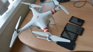 Prison Guard grabs a drone containing phones and drugs after intercepting its signal forcing it descend!