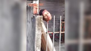 Brazil - gang war: a severed head on an iron fence