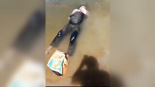 The corpse of a brutally executed woman floats on the water