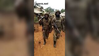 Soldiers dragging a corpse