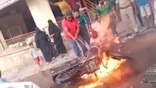 Ten people are injured after motorcycle explodes while trying to extinguish fire - India