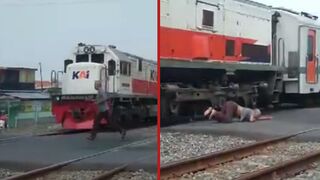 Train knocks elderly man to the ground whilst he attempted to cross tracks - Indonesia