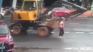 Woman gets run over by an excavator whilst walking in the road - Vietnam