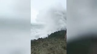 Tourists were washed into the ocean by a huge wave