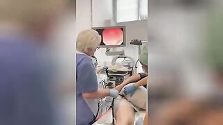 Proctologist extracting a huge cucumber from a man’s anus