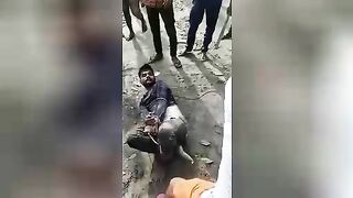 Hindu being beaten with a stick. India. Video.