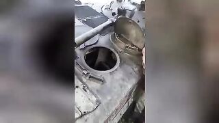 The corpse of a Russian soldier stuck in the hatch of the IFV