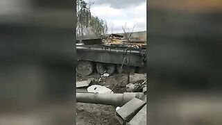 Corpse of a Russian soldier near a destroyed tank.