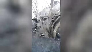 Corpse of a Russian soldier near a fuel truck.