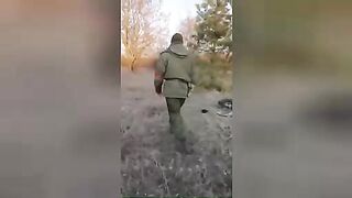 LPR fighter demonstrates the corpses of Ukrainian soldiers