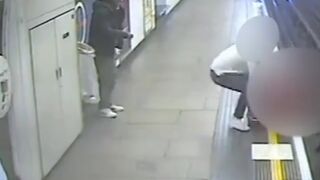 Guy gets pushed onto subway tracks, but is saved at the last second