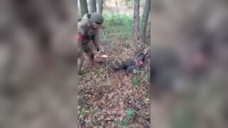 Russian soldier plays with the corpse of a Ukrainian and throws his own boot at him