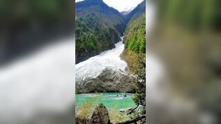 Massive avalanche rolling down into a lake